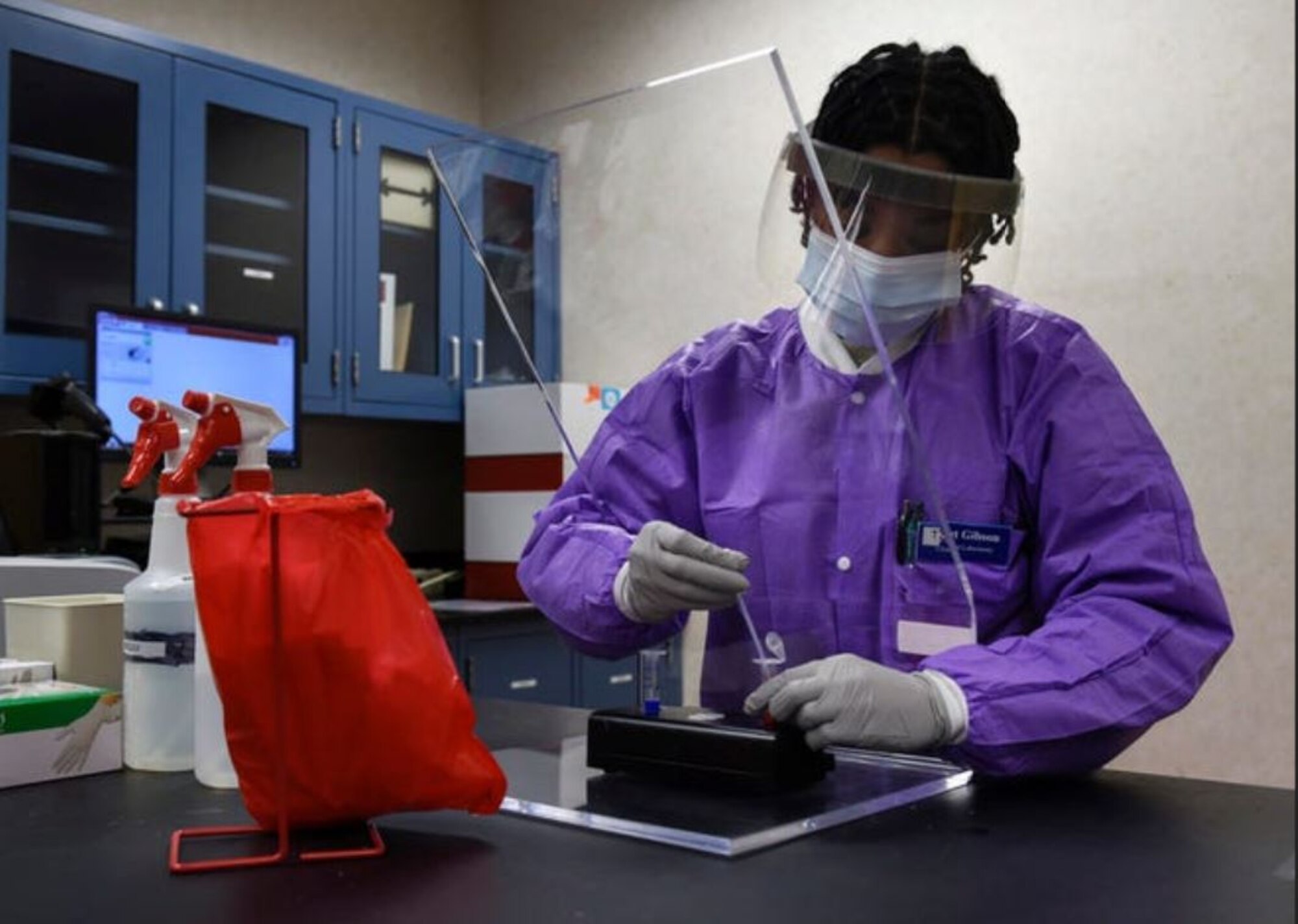 Tech Sgt. Jonisha Gibson, 82nd Medical Group clinical laboratory noncommissioned officer in charge, prepares a sample for diagnostic testing at Sheppard Air Force Base, Texas, April 9. Since the establishment of the Department of the Air Force Acquisition COVID-19 Task Force in late March, the Digital Directorate has been assisting the Department of Health and Human Services in awarding contracts aimed at boosting the domestic production of COVID-19 testing equipment and supplies. (U.S. Air Force photo by Senior Airman Pedro Tenorio)