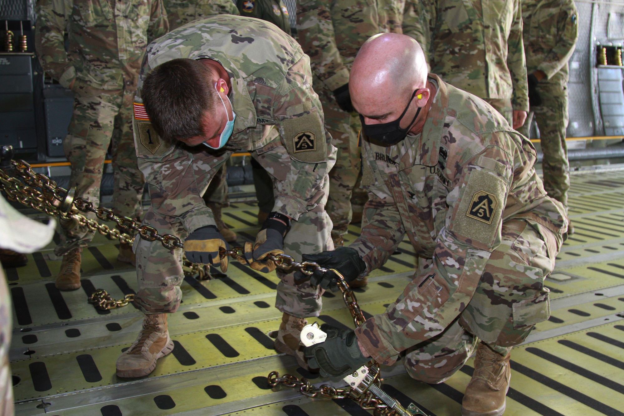 Col. Charles Brundrett (right), U.S. Army North’s Task Force 51’s operations officer, and Lt. Col. Jeremy Gottshall (left), U.S. Army North Task Force 51’s logistic officer, in charge work together to chain down a vehicle, during the unit’s Level II Deployment Readiness Exercise at Joint Base San Antonio-Kelly Field Annex Nov. 20.