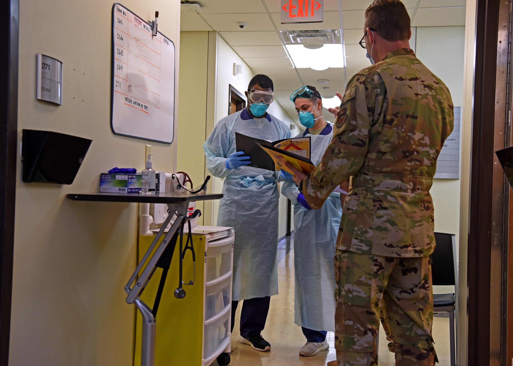 U.S. Air Force Lt. Col. James Kopp, 17th Medical Group chief of medical staff, communicates with the COVID-19 screening team prior to an influx of patients at the Ross Clinic on Goodfellow Air Force Base, Texas, Nov. 23, 2020. Kopp frequently visited the COVID screening hall to answer any questions that might have come up. (U.S. Air Force photo by Senior Airman Abbey Rieves)