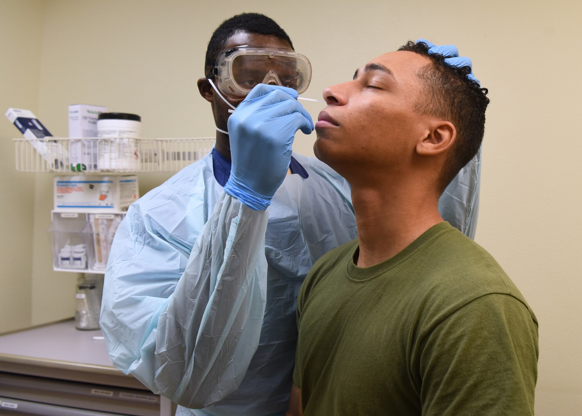 U.S. Air Force Senior Airman Marckus Humphries, 17th Operational Medical Readiness Squadron aerospace medical technician, conducts a rapid COVID-19 screening test on a patient at the Ross Clinic on Goodfellow Air Force Base, Texas, Nov. 23, 2020. All recovered members who previously tested positive for the virus were encouraged to donate their COVID Convalescent Plasma to help treat hospitalized COVID patients. (U.S. Air Force photo by Senior Airman Abbey Rieves)