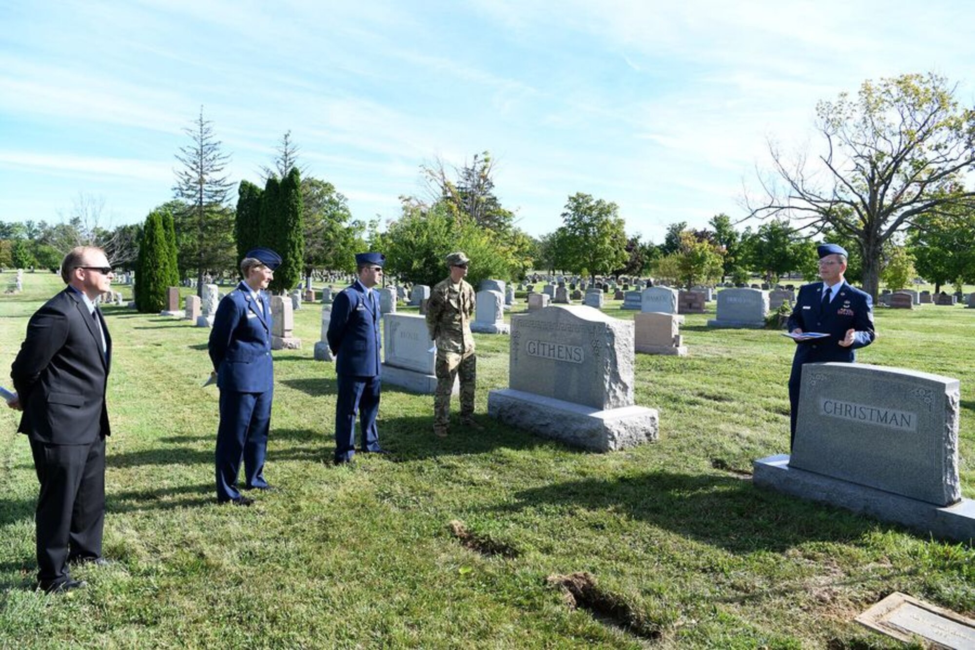 Tech. Sgt. Richard Herron, the base historian and an Airman assigned to the 162nd Operations Group, presents the new headstone for Lt. Richard Christman, a pilot assigned to the 162nd Fighter Squadron in 1948, September 4, 2020 at Dayton Memorial Park Cemetery in Dayton, Ohio. On September 4, 1948, Christman was flying a routine navigational training mission above Dayton, Ohio when his F-51’s left wing broke off of the aircraft at several thousand feet in the air. The F-51 crashed and 27-year-old Christman died in the crash. (U.S. Air National Guard photo by Staff Sgt. Amber Mullen)