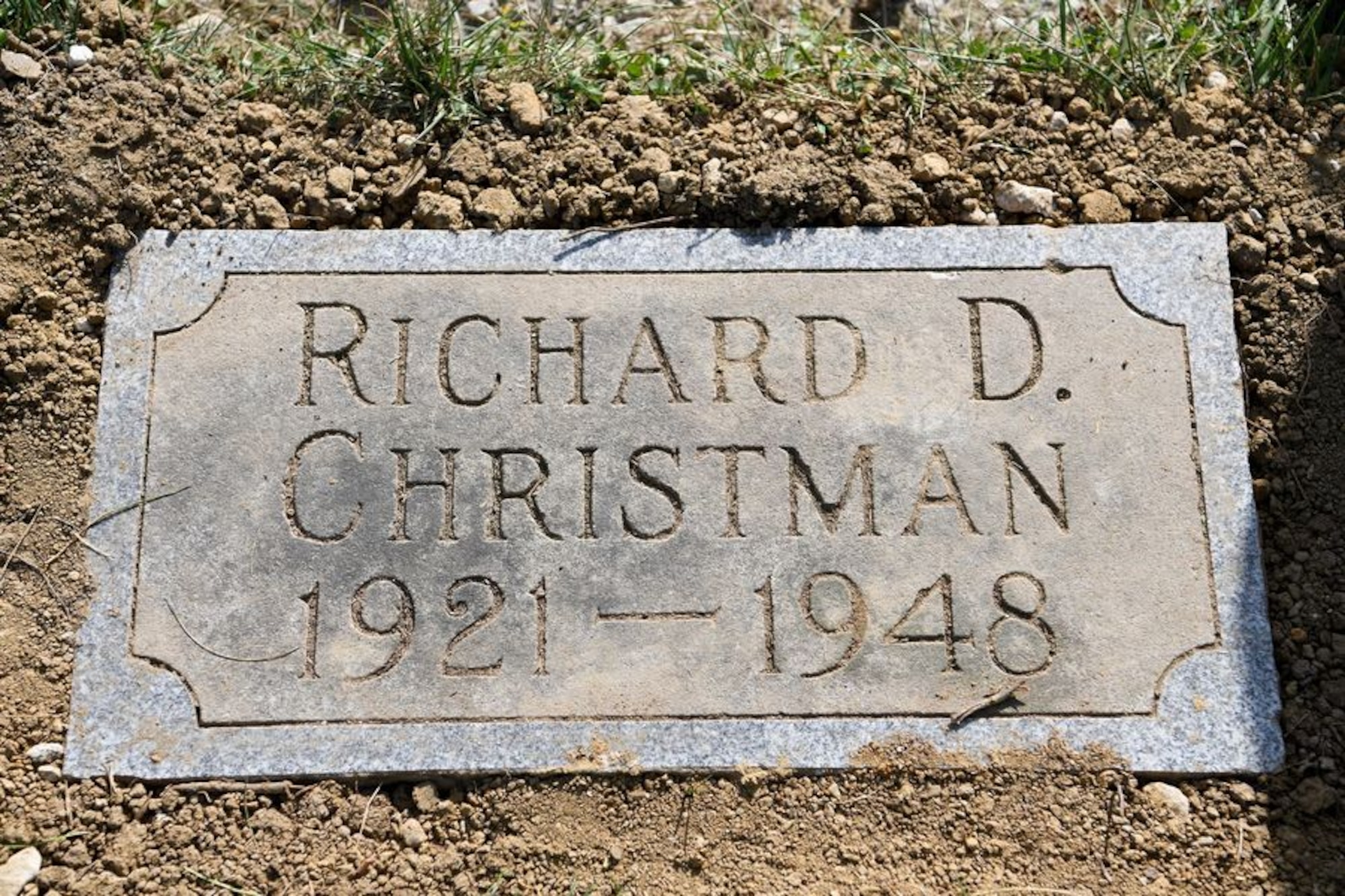 Tech. Sgt. Richard Herron, the base historian and an Airman assigned to the 162nd Operations Group, presents the new headstone for Lt. Richard Christman, a pilot assigned to the 162nd Fighter Squadron in 1948, September 4, 2020 at Dayton Memorial Park Cemetery in Dayton, Ohio. On September 4, 1948, Christman was flying a routine navigational training mission above Dayton, Ohio when his F-51’s left wing broke off of the aircraft at several thousand feet in the air. The F-51 crashed and 27-year-old Christman died in the crash. (U.S. Air National Guard photo by Staff Sgt. Amber Mullen)