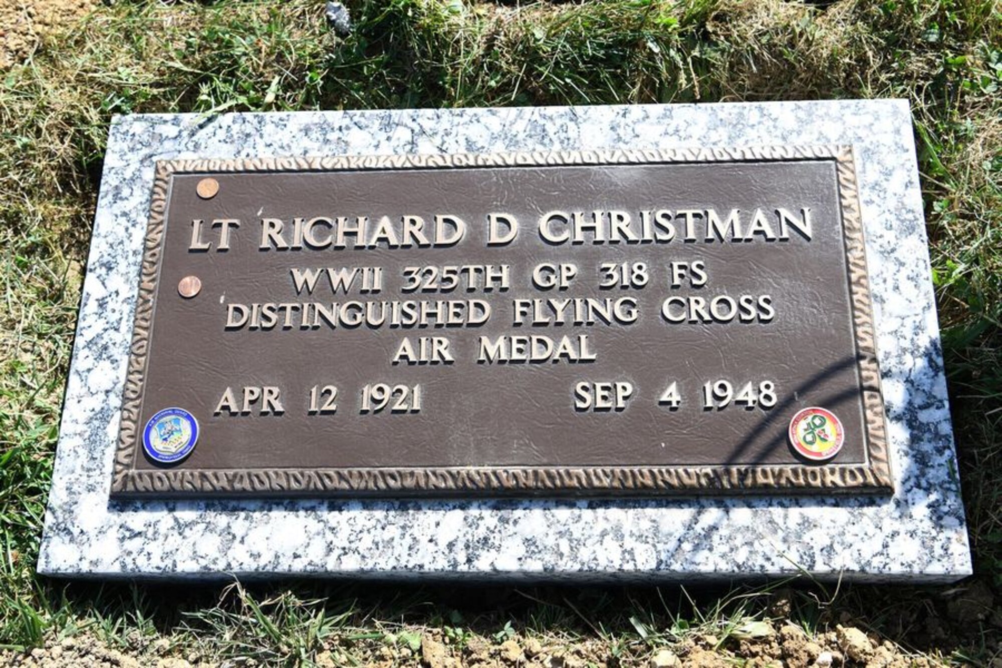 Tech. Sgt. Richard Herron, the base historian and an Airman assigned to the 162nd Operations Group, presents the new headstone for Lt. Richard Christman, a pilot assigned to the 162nd Fighter Squadron in 1948, September 4, 2020 at Dayton Memorial Park Cemetery in Dayton, Ohio. On September 4, 1948, Christman was flying a routine navigational training mission above Dayton, Ohio when his F-51’s left wing broke off of the aircraft at several thousand feet in the air. The F-51 crashed and 27-year-old Christman died in the crash. (U.S. Air National Guard photo by Staff Sgt. Amber Mullen)