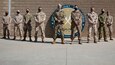 Service members from the Combined Joint Task Force - Operation Inherent Resolve Directorate of Military Assistance stand for a photo on Camp Arifjan, Kuwait, November 14, 2020. The DMA is a joint force initiative that supports the divestment of critical resources, training, and funding to vetted partner forces throughout the U.S. Army Central Command area of operations.