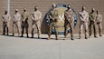 Service members from the Combined Joint Task Force - Operation Inherent Resolve Directorate of Military Assistance stand for a photo on Camp Arifjan, Kuwait, November 14, 2020. The DMA is a joint force initiative that supports the divestment of critical resources, training, and funding to vetted partner forces throughout the U.S. Army Central Command area of operations.