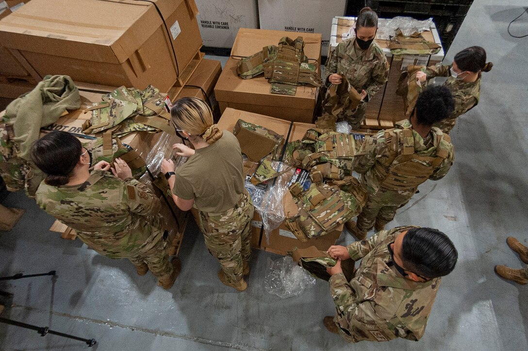 Photo of Airmen preparing to try on new armor