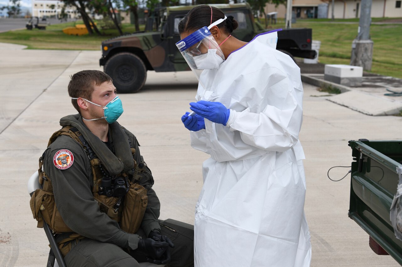 A pilot interacts with a woman with a clipboard.