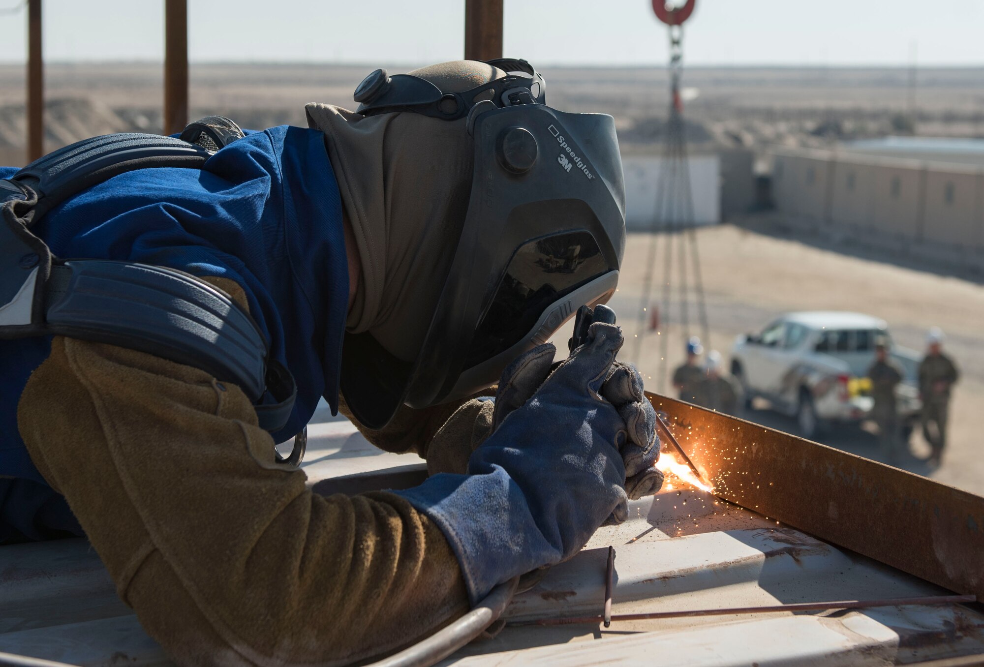 A U.S. Air Force Airman assigned to the 386th Expeditionary Civil Engineer Squadron structures unit welds a rail to a conex at Ali Al Salem Air Base, Kuwait, Nov. 23, 2020.