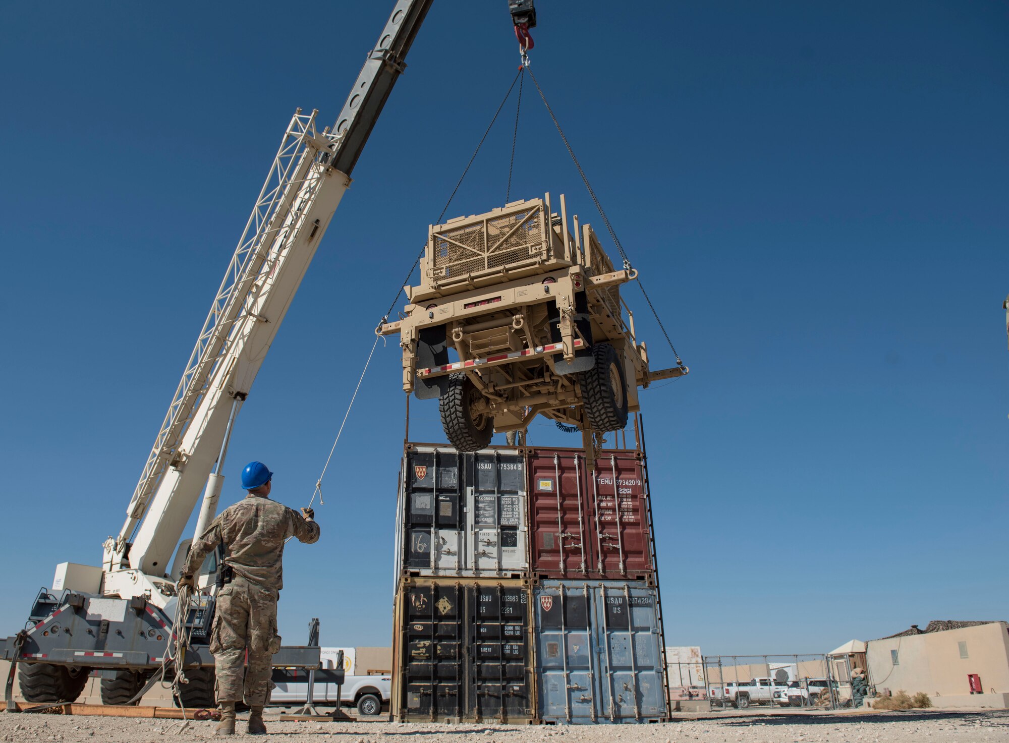U.S. Air Force Airmen assigned to the 386th Expeditionary Civil Engineer Squadron pavement and heavy equipment operator unit lift an AN/MQP-64 Sentinel radar system at Ali Al Salem Air Base, Kuwait, Nov. 23, 2020.