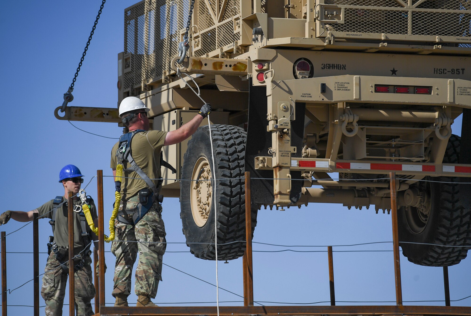 U.S. Air Force Airmen assigned to the 386th Expeditionary Civil Engineer Squadron structures unit guide the placement of an AN/MQP-64 Sentinel radar at Ali Al Salem Air Base, Kuwait, Nov. 23, 2020.