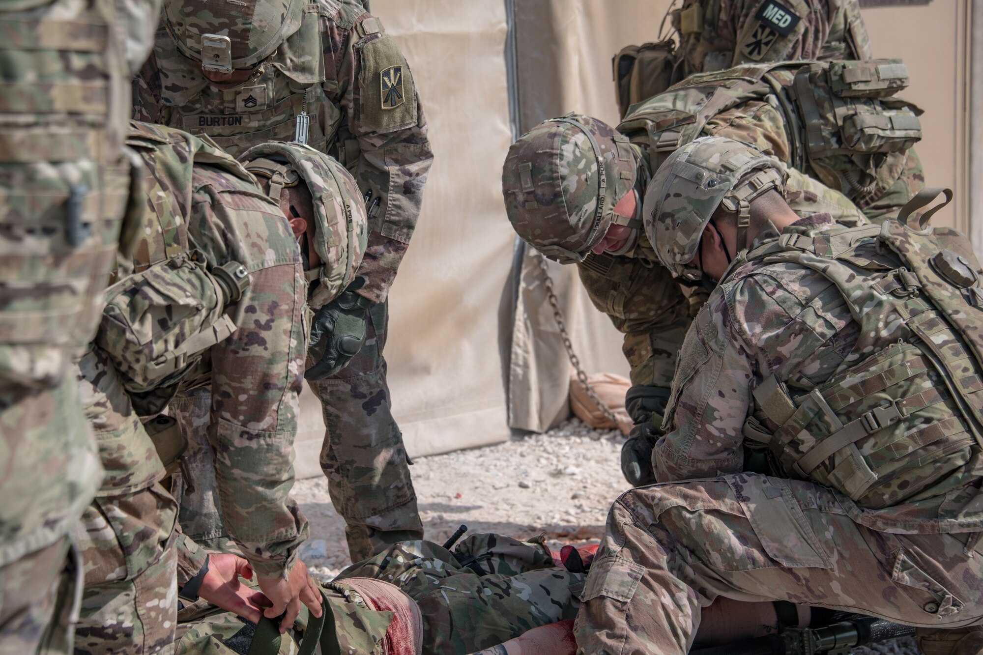 U.S. soldiers treat a simulated patient with wounds