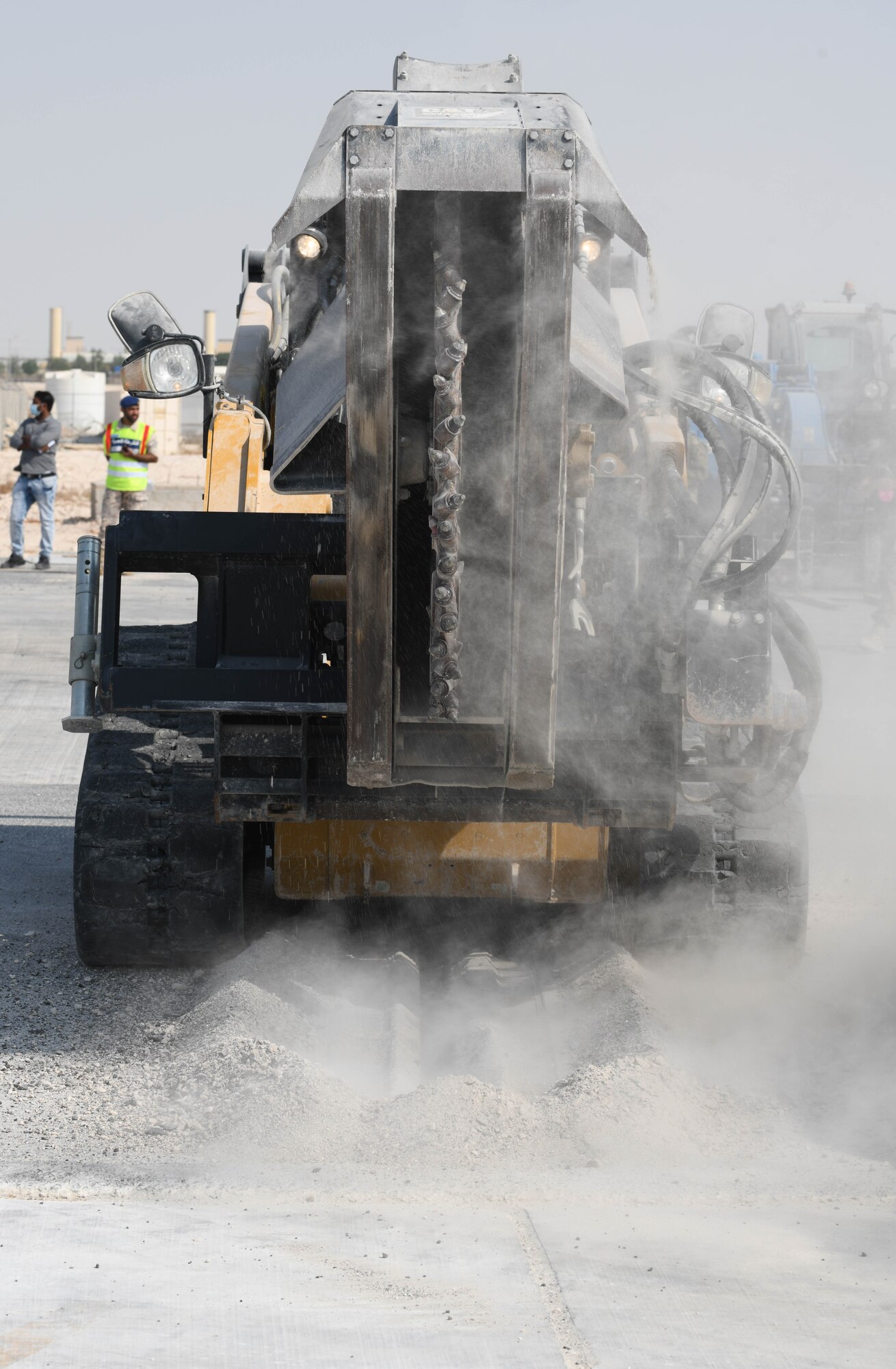 U.S. Airmen assigned to the 379th Expeditionary Civil Engineer Squadron operate and direct compact track loaders with saw attachments during rapid airfield damage repair training at Al Udeid Air Base, Qatar, Nov. 18. 2020. RADR training brought together ECES Airmen from multiple disciplines, including the explosive ordnance disposal branch, to clear a mock airfield of simulated unexploded ordnance and repair it after a notional attack. (U.S. Air Force photo by Staff Sgt. Kayla White)