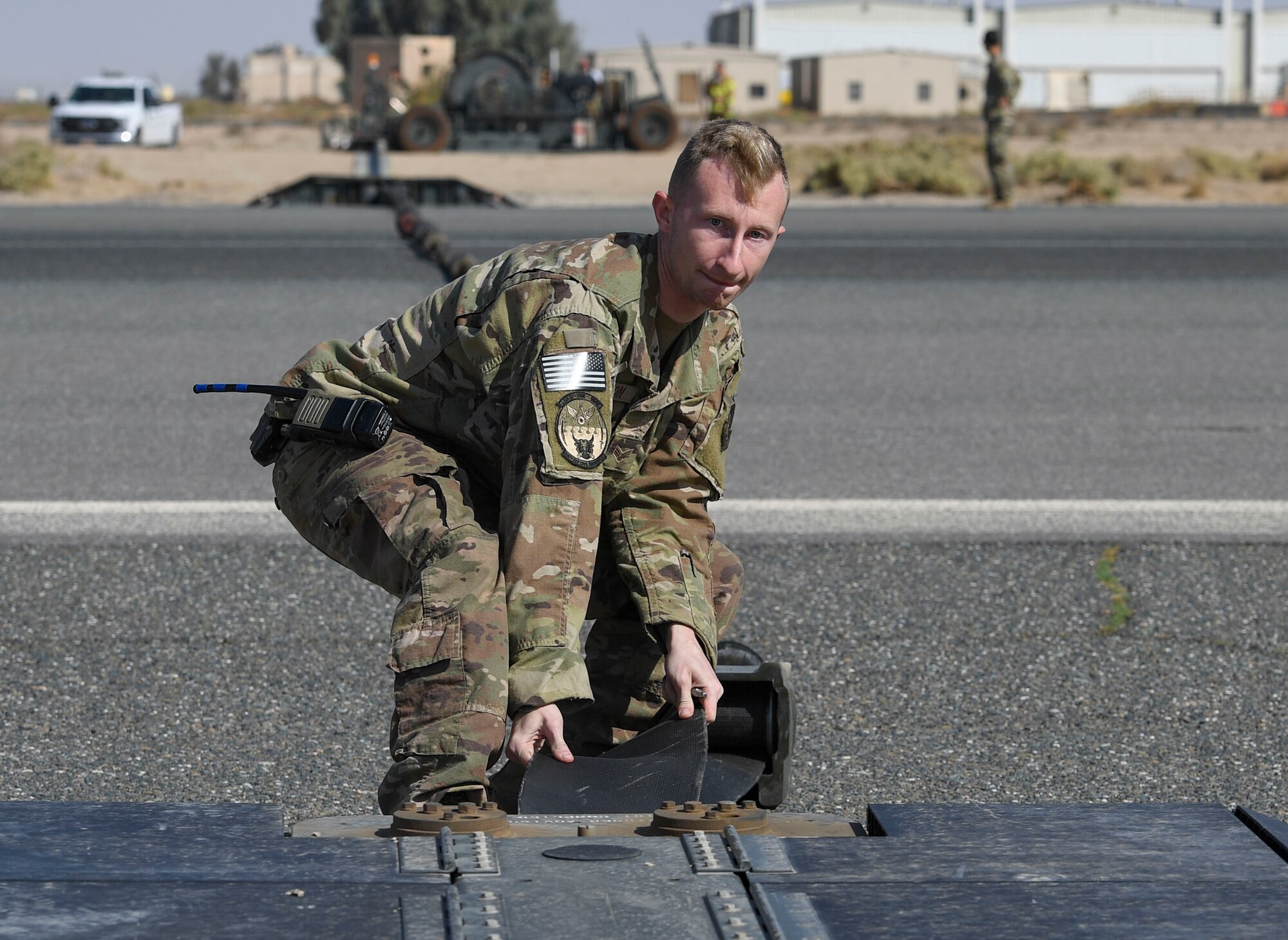 U.S. Air Force Senior Airman Benjamin Wilson, 386th Expeditionary Civil Engineer Squadron electrical power production journeyman, adjusts a component of the Mobile Aircraft Arresting System during a MAAS certification at Ali Al Salem Air Base, Kuwait, Nov. 22, 2020.