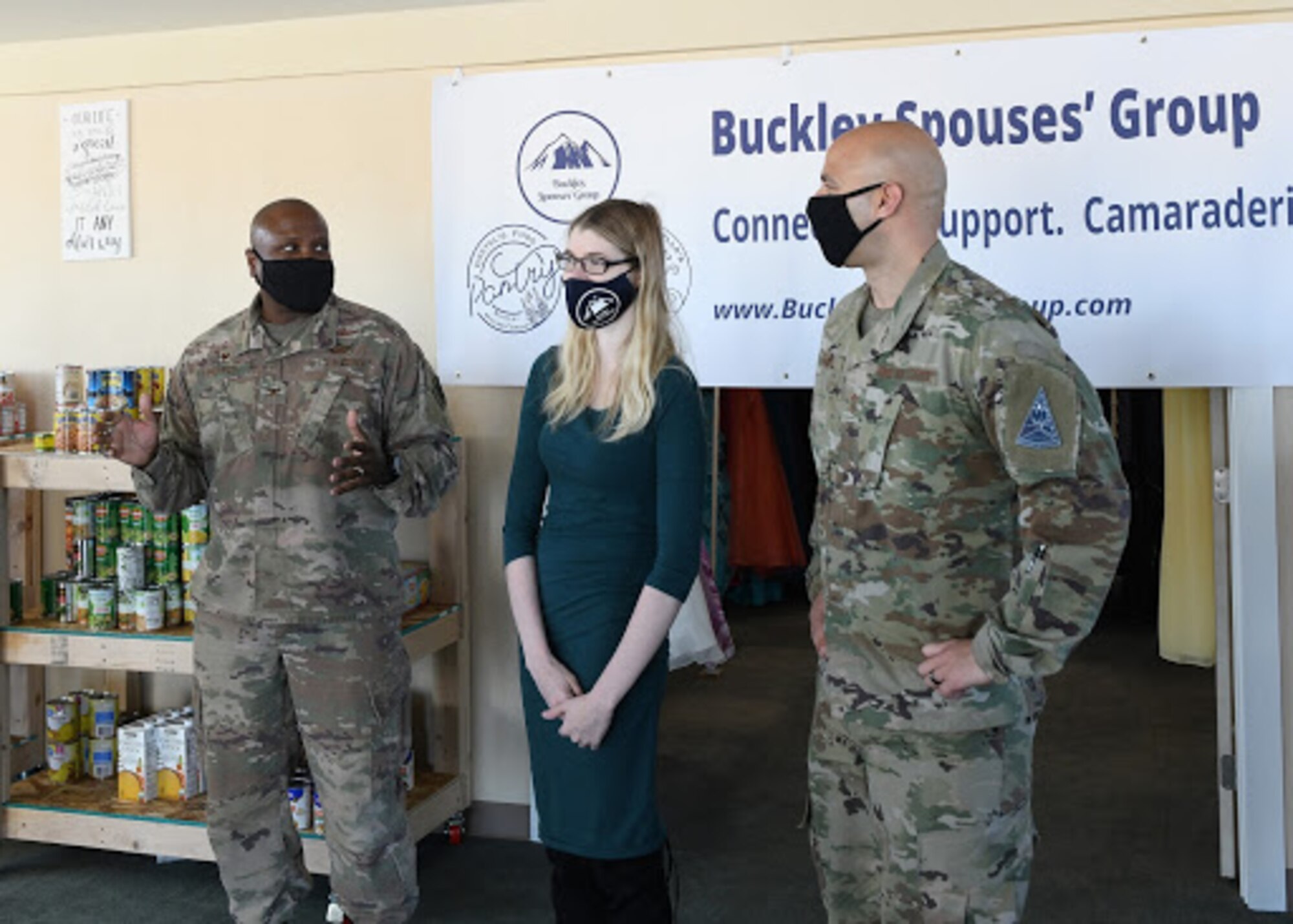 Col. Devin Pepper, Buckley Garrison commander, and Chief Master Sgt. Robert Devall, Buckley Garrison command chief, speak to Rachel Crist, Buckley Spouses’ Group treasurer, at the grand opening of Gretel’s Food Pantry on Buckley Air Force Base, Colo., Nov. 25, 2020. Crist conducted a survey across base that returned over 120 responses revealing the critical need for food assistance on Buckley. (U.S. Space Force photo by Airman 1st Class Haley N. Blevins)