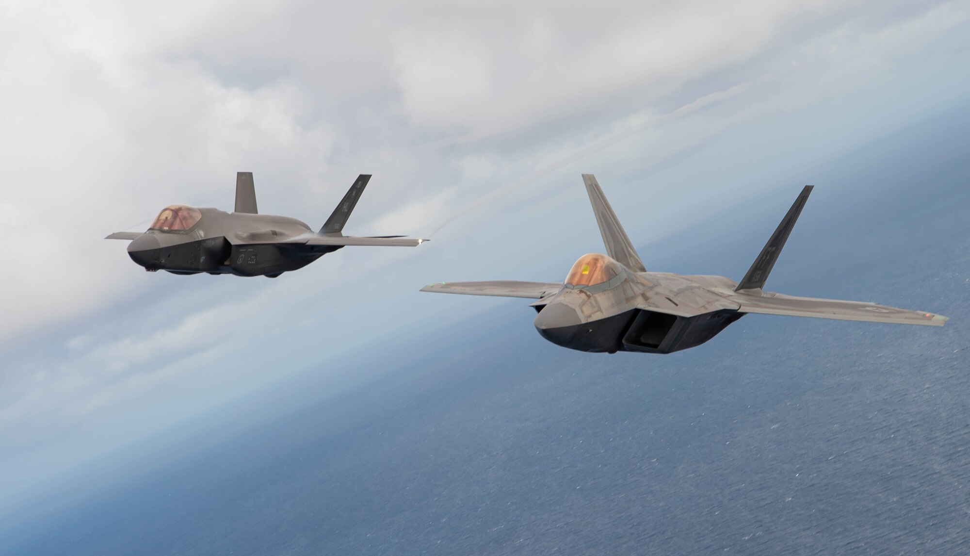 An F-22 Raptor and F-35A Lightning II fly in formation near Fort Lauderdale, Fla., Nov. 20, 2020. The fighter jets, along with the C-17 West Coast Demo Team from Joint Base Lewis-McChord, Wash., participated in the two-day 2020 Fort Lauderdale Air Show. (U.S. Air Force photo by Senior Airman Tryphena Mayhugh)