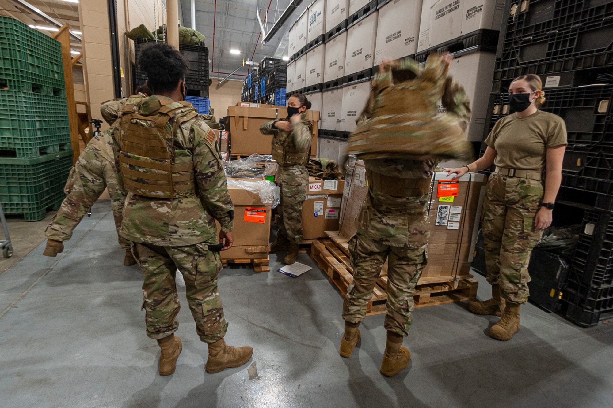Photo of Airmen trying on vests