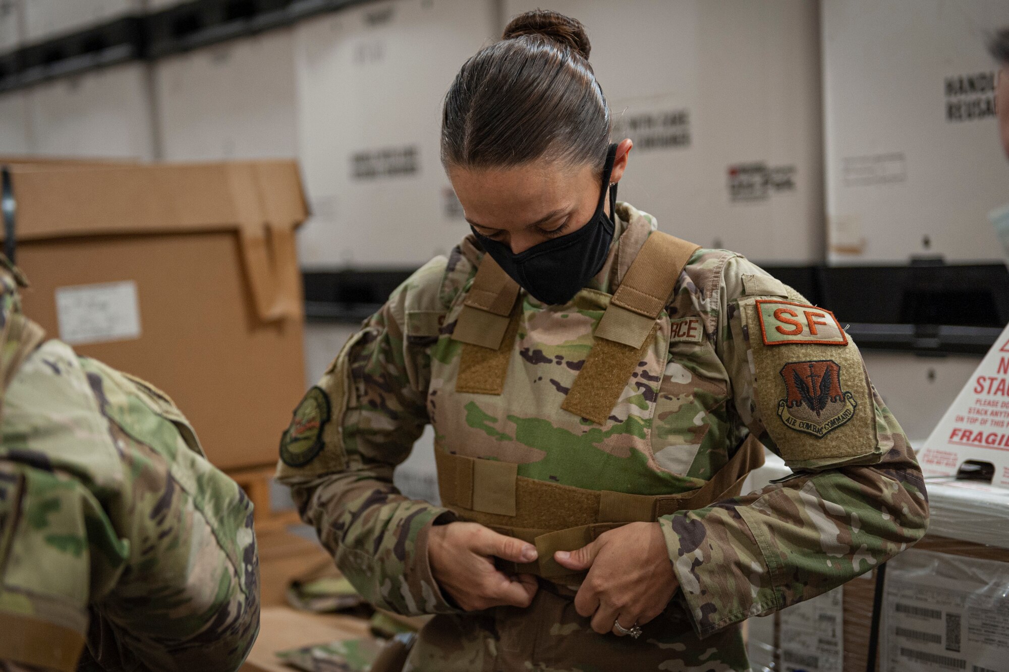 Photo of an Airman adjusting a vest