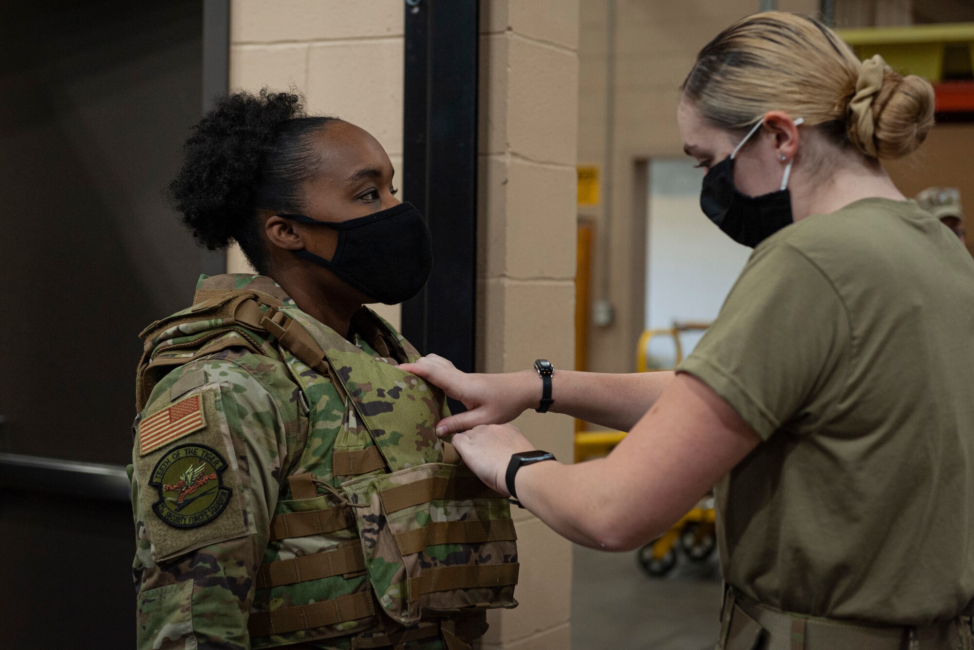 Photo of an Airman adjusting a vest