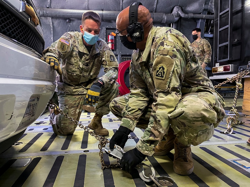 Staff Sgt. Whitfield Leach (right), U.S. Army North’s Task Force 51’s aide-de-camp, tightens down chains attached to an emergency response vehicle as Lt. Col. Jeremy Gottshall (left), U.S. Army North’s Task Force 51’s logistic officer in charge, observes during the unit’s Level II Deployment Readiness Exercise at Joint Base San Antonio-Kelly Field Annex Nov. 20.