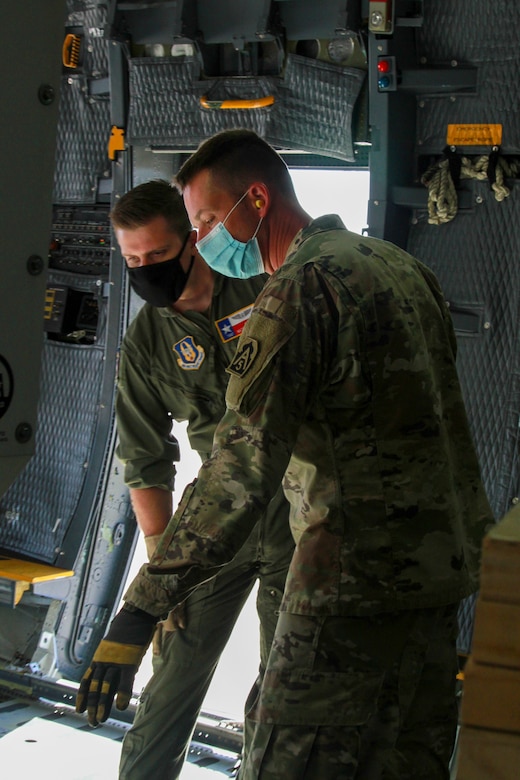 Lt. Col. Jeremy Gottshall (right), U.S. Army North’s Task Force 51’s logistic officer in charge, talks with Air Force Tech Sgt. Matt Legendre (left), a loadmaster assigned to the 68th Airlift Squadron, during the unit’s Level II Deployment Readiness Exercise at the Joint Base San Antonio-Kelly Field Annex Nov. 20.