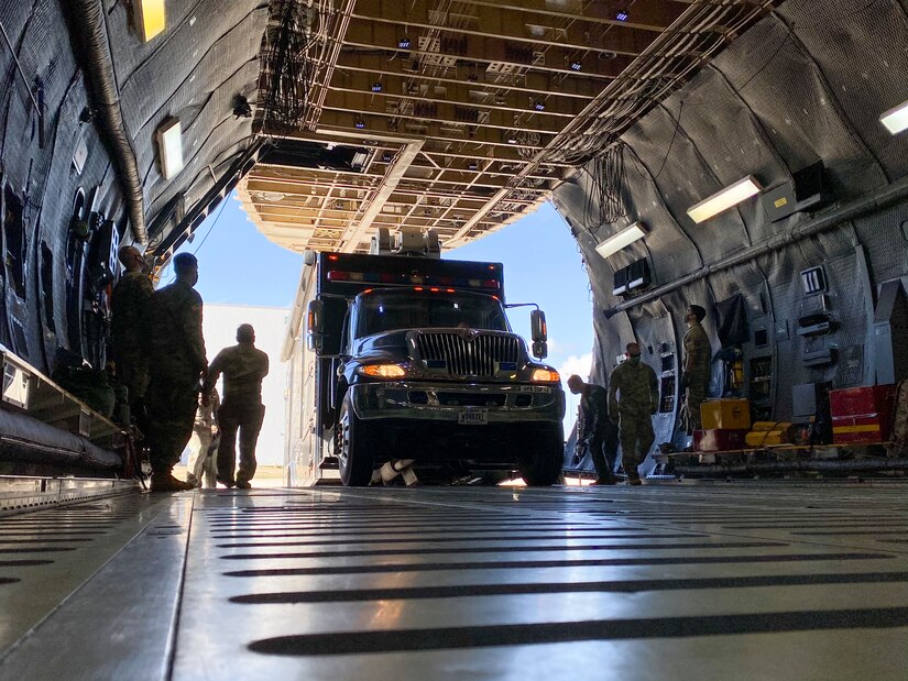 Soldiers assigned to U.S. Army North’s Task Force 51 and Airmen assigned to the 68th Airlift Squadron load the Sentinel, otherwise known as ARNORTH’s mobile command post, during the unit’s Level II Deployment Readiness Exercise at Joint Base San Antonio-Kelly Field Annex Nov. 20.