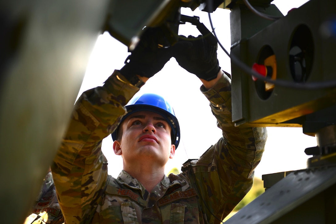 Airman 1st Class Devon Herre, 606th Air Control Squadron tactical satellite communications technician, works on a quadband large aperture antenna during exercise Astral Knight 20 at Malbork Air Base, Poland, Sept. 23, 2020. The QLAA can transmit data to the Control and Reporting Center at Aviano Air Base, Italy. (U.S. Air Force photo by Tech. Sgt. Tory Cusimano)