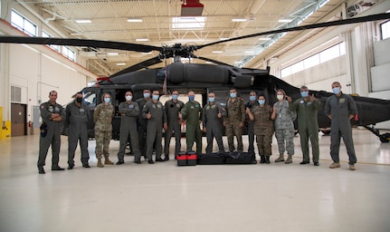 Members from the Tunisian Air Force and Wyoming National Guard in front of a UH-60 Black Hawk helicopter at the Army Aviation Support Facility on F. E. Warren Air Force Base, Cheyenne, Wyo., Sept. 16, 2020. The Tunisians attended the Aviation Familiarization Event hosted by the Wyoming National Guard under the State Partnership Program. =