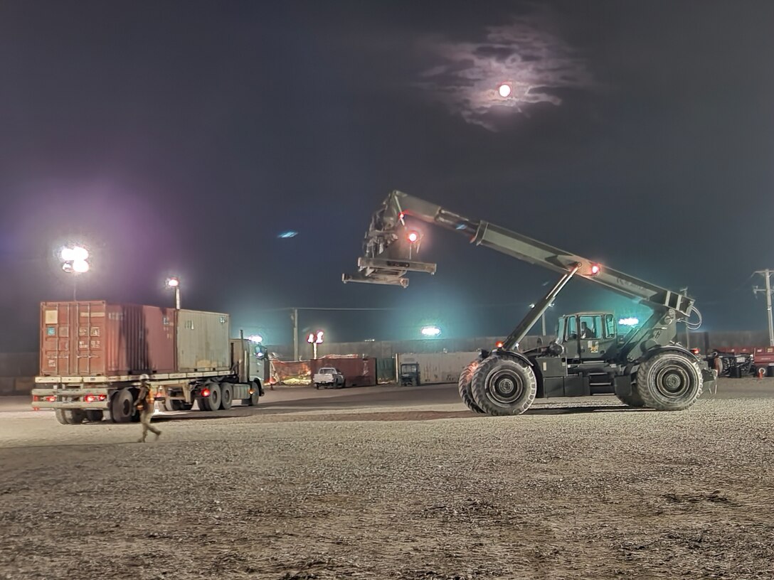 Defense Logistics Agency personnel take to the night to clear containers from a receiving and shipping point on Bagram Airfield, Afghanistan.