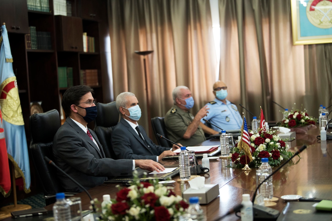 Men receive briefing at conference table