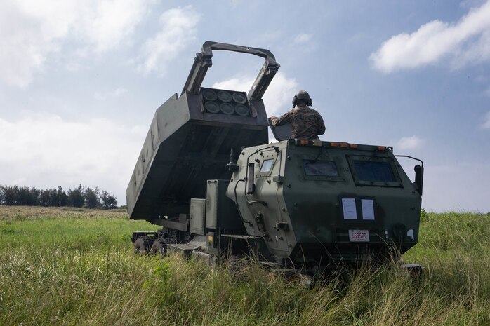 U.S. Marines conduct a fire mission during a High Mobility Artillery Rocket System rapid infiltration exercise at Ie Shima, Japan, Sept. 24.