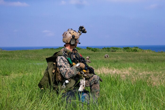 A U.S. Marine provides security after completing a high altitude-low opening jump to secure an airfield, facilitating a High Mobility Artillery Rocket System rapid infiltration and simulated firing mission at Ie Shima, Japan, Sept. 24.