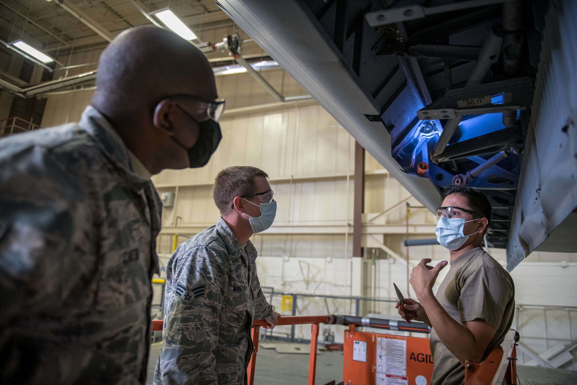 Tech. Sgt. Jesse Zambrano, 302nd Maintenance Squadron C-130 crew chief, right, discusses the process of installing major flight controls in a C-130 Hercules with C-40C crew chiefs, Senior Airman Landon Wineland, middle, and Senior Airman Earnest Carter, both from the 932nd Maintenance Group, September 16, 2020, Peterson Air Force Base, Colorado.  Citizen Airmen with the 932nd, 910th and 302nd Airlift Wing’s participated in operation centennial summit, to build relations with sister wings.  “The opportunity to see other airframes and learn best practices was a great opportunity,” said Wineland. (U.S. Air Force photo by Master Sgt. Christopher Parr)