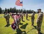 Acting battalion commander Maj. Becky Lux (right) and Command Sgt. Maj. Bunesiha Jones case the colors of the Warrior Transition Battalion with Col. Thomas Bundt, commander of Madigan Army Medical Center, as part of the redesignation ceremony to the new name of Soldier Recovery Unit on Thursday, June 25, 2020, on Joint Base Lewis-McChord in Tacoma, Washington.