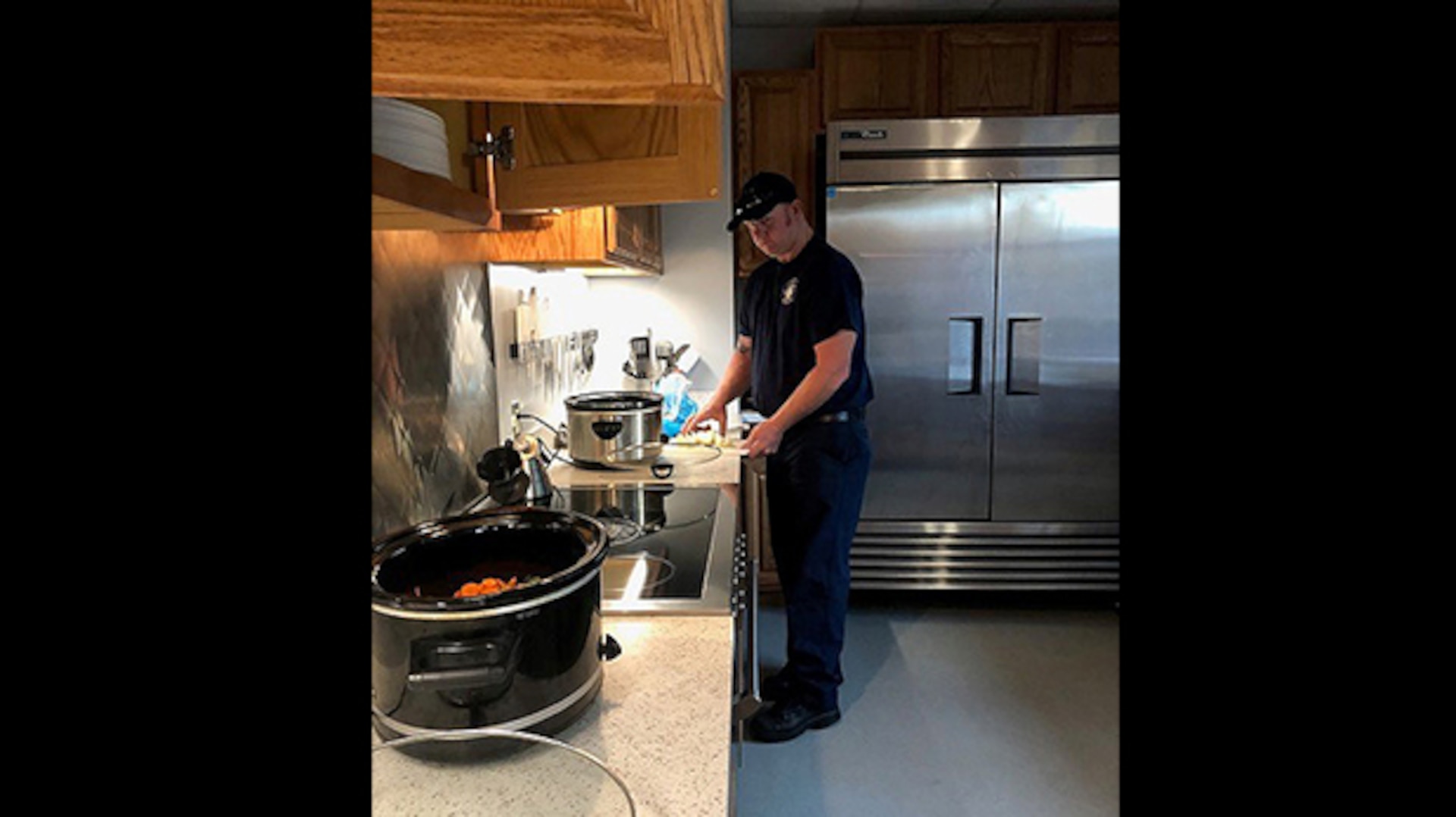 Firefighter cooks dinner for coworkers
