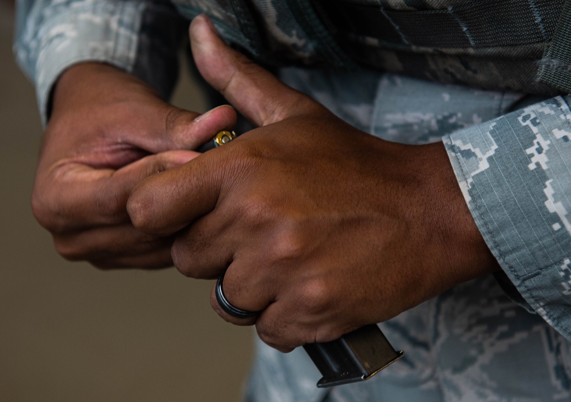 A member of the 633rd Security Forces Squadron loads ammunition into a magazine during M18 qualification testing at Joint Base Langley-Eustis, Virginia, Sept. 24, 2020.