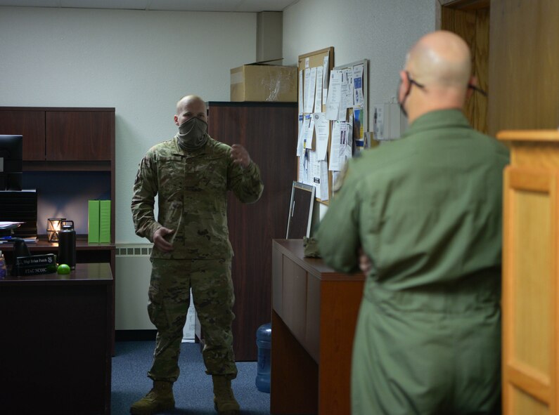 U.S. Air Force Staff Sgt. Brian Futch, the 354th Force Support Squadron First-Term Airman Center instructor, talks with Col. David Berkland, the 354th Fighter Wing commander, during a wing leadership immersion on Eielson Air Force Base, Alaska, Sept. 29, 2020. Berkland visited the Professional Military Education center to talk with the team responsible for the professional development of Eielson Airmen. (U.S. Air Force photo by Senior Airman Beaux Hebert)