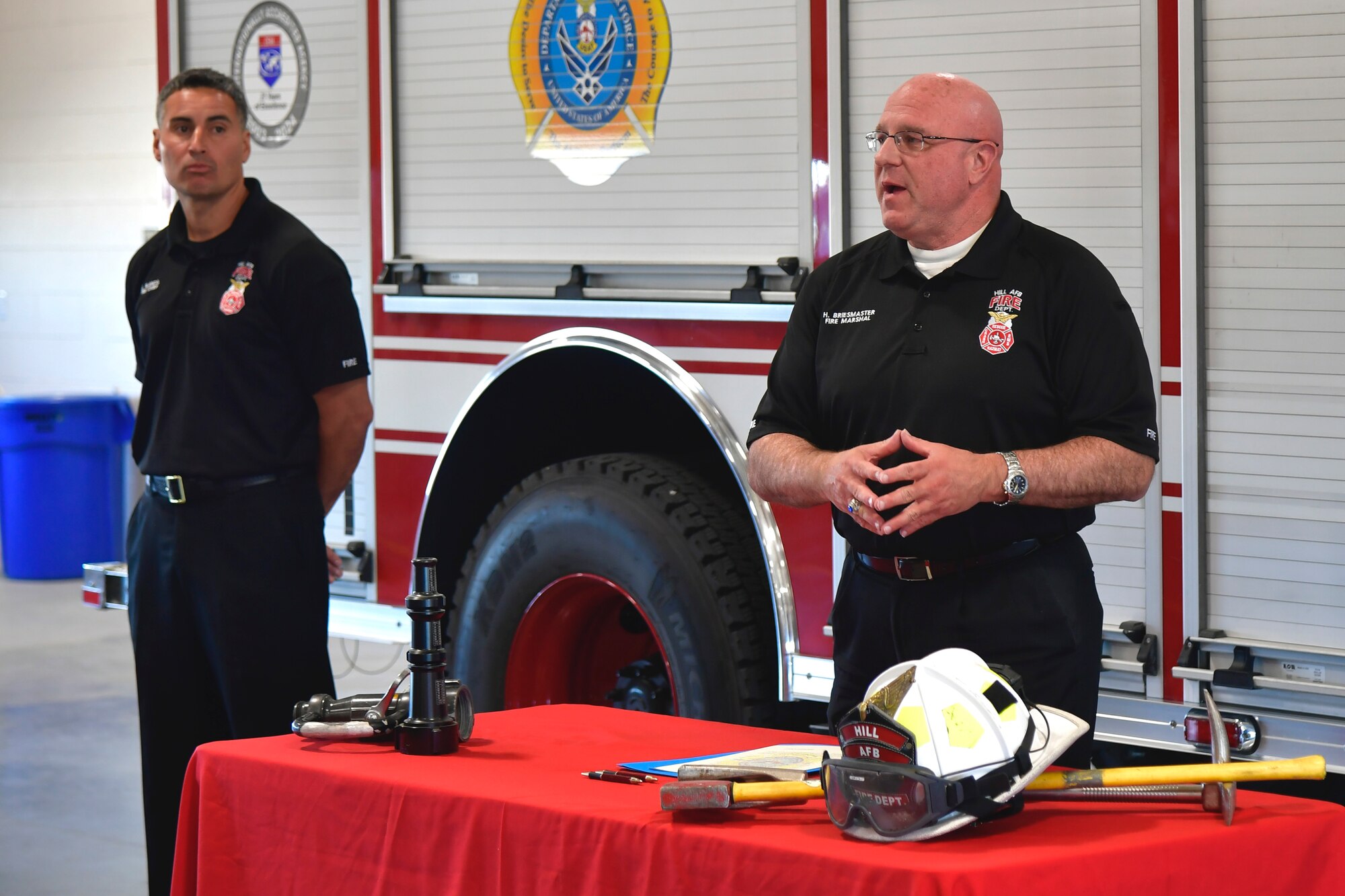 Harry Briesmaster, 75th Civil Engineer Group director and fire marshal, speaks to firefighters during the signing ceremony for the base’s Fire Prevention Week proclamation.