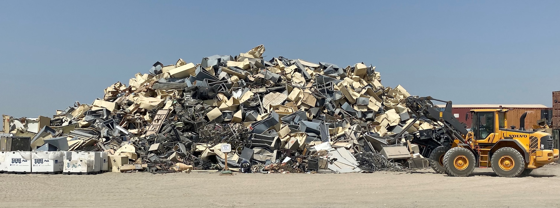 Material handlers gather scrap materials to prepare for removal operations to begin.