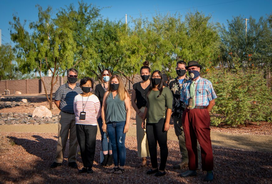 Group poses for photo in park.