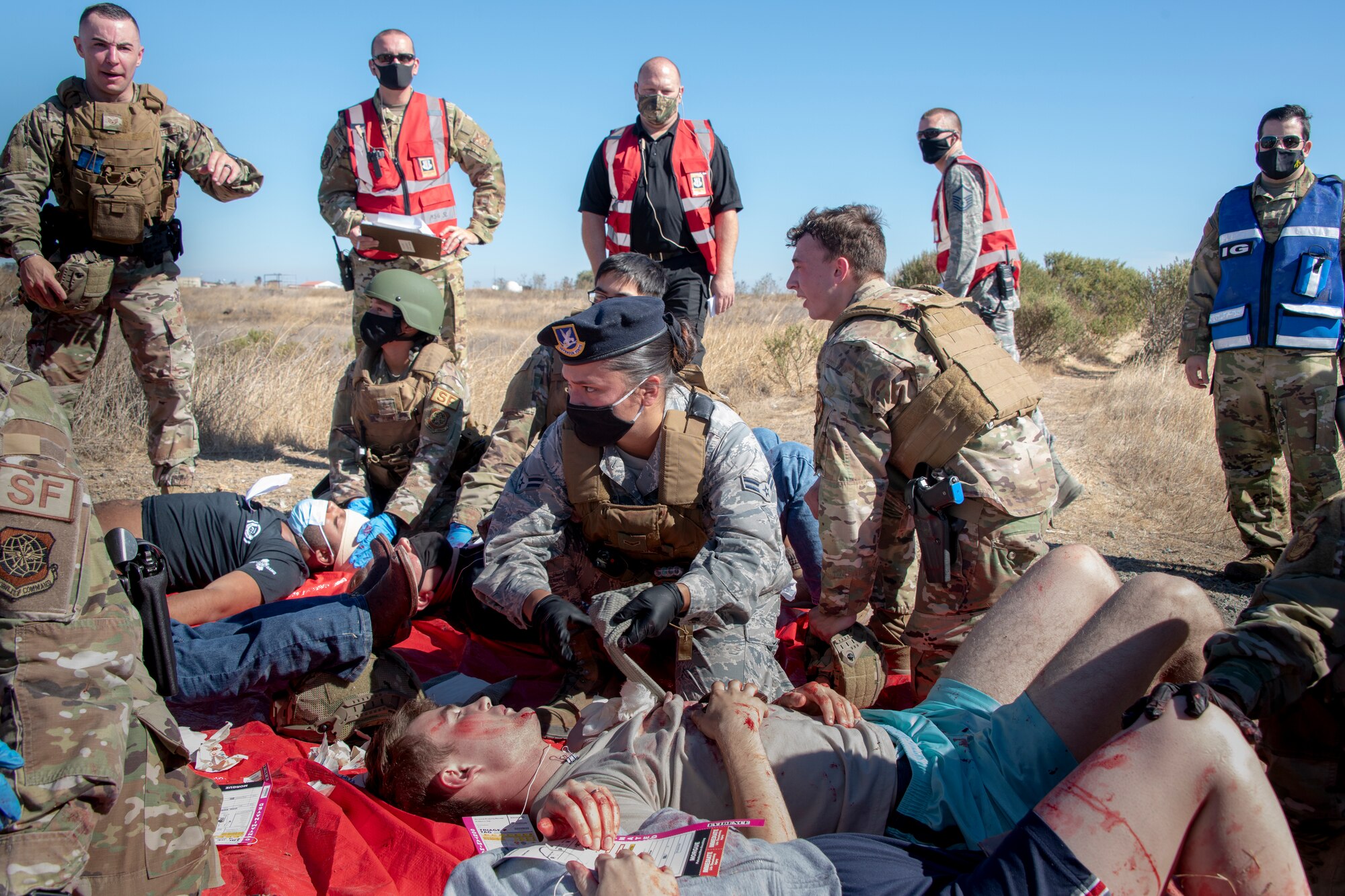 U.S. Airmen assigned to the 60th Security Forces Squadron attend to in a base exercise Sept. 24, 2020, at Travis Air Force Base, California. The exercise was designed to evaluate the training, readiness and capability of Travis first responders in order to effectively respond to active shooter threats to the installation. (U.S. Air Force photo by Heide Couch