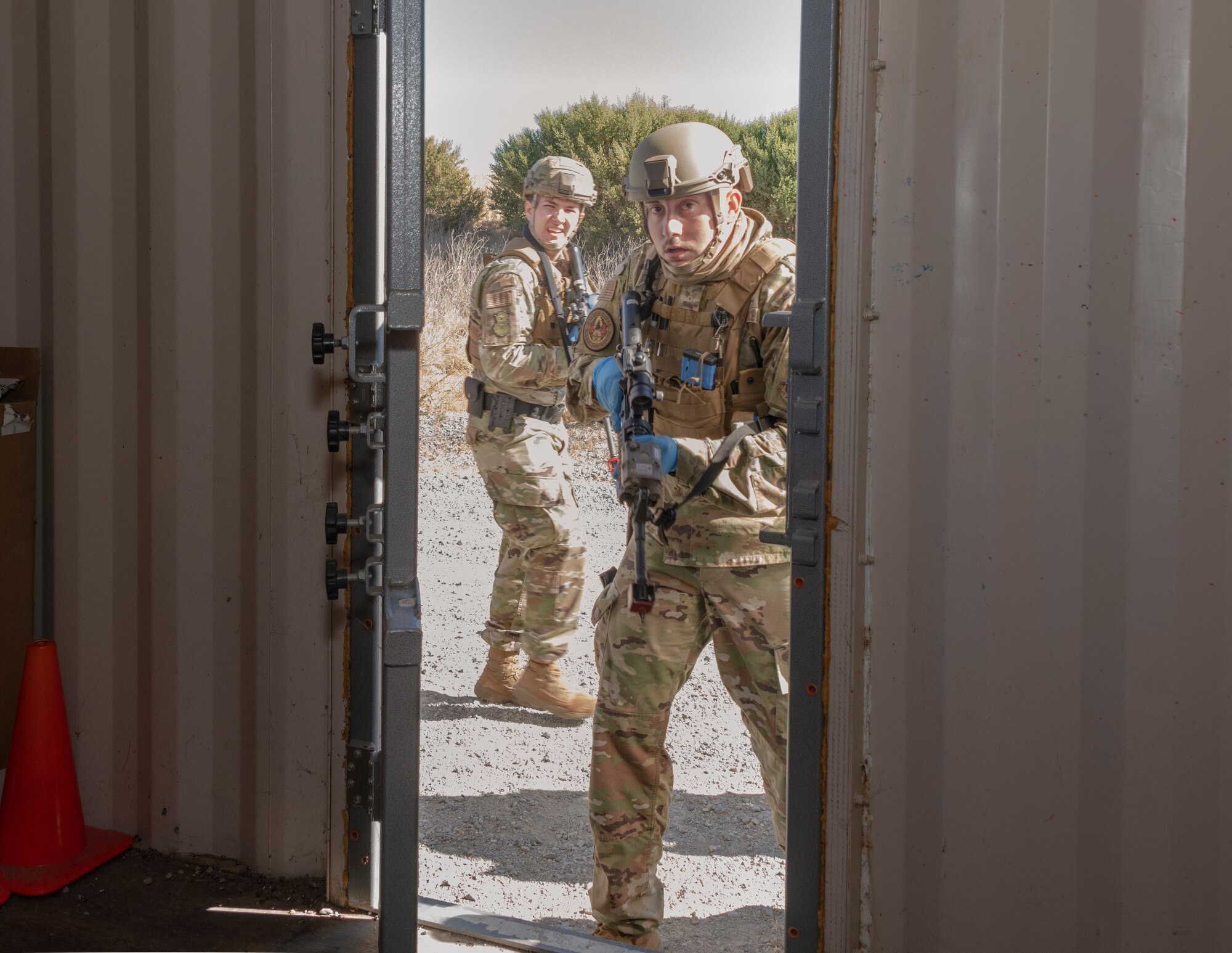 U.S. Air Force Senior Airman Dalton Short, right, 60th Security Forces Squadron installation patrolman, and Airman 1st Class Blake Crowell, 60th SFS installation patrolman, gain entry to a building to search for threats during a base exercise Sept. 24, 2020, at Travis Air Force Base, California. The exercise was designed to enhance the training, readiness and capability of Travis first responders in order to effectively respond to active shooter threats to the installation. (U.S. Air Force photo by Heide Couch)