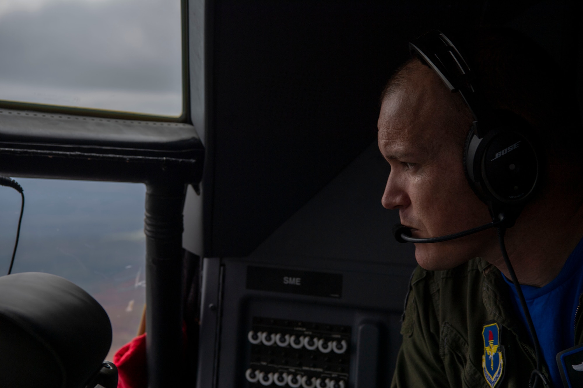 The 62nd Airlift Squadron commander looks out of the cockpit on a C-130.