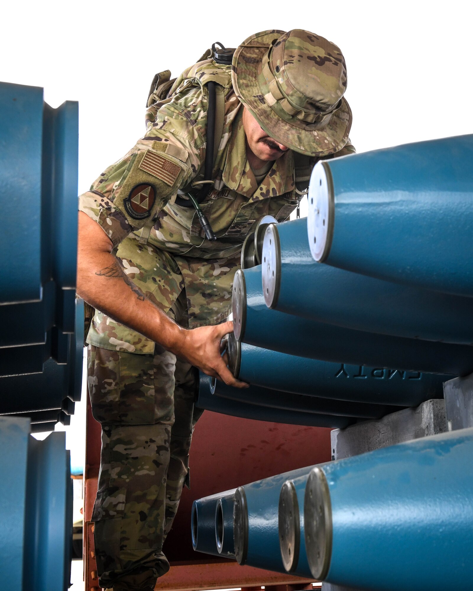 Airman 1st Class Tyler Drummund,  56th Equipment Maintenance Squadron munitions systems technician, removes shipping caps from GBU-12 Paveway II laser-guided bombs Sept 22, 2020, at Luke Air Force Base, Arizona.