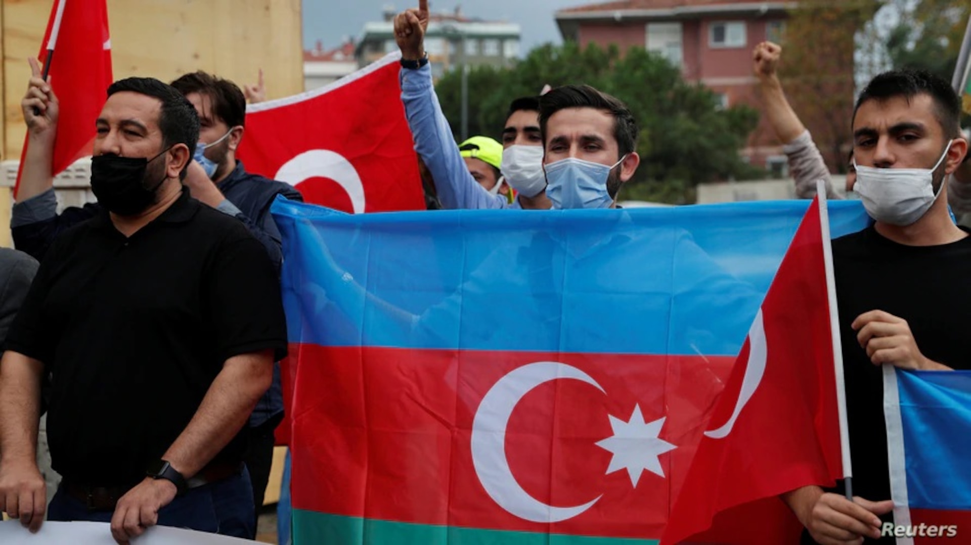 Demonstrators holding Azeri and Turkish flags shout slogans during a protest against Armenia near the Consulate of Azerbaijan in Istanbul, Turkey, Sept. 29, 2020.