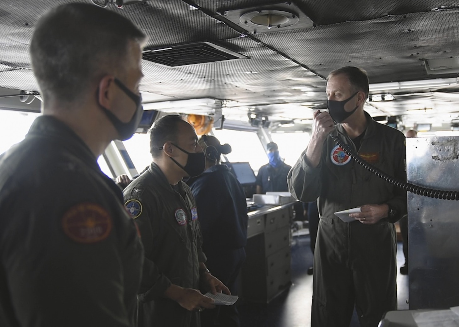 PHILIPPINE SEA (Oct. 1, 2020) Rear Adm. George Wikoff commander, Task Force 70, right, speaks at a change-of-command ceremony in the pilot house of the Navy’s only forward-deployed aircraft carrier USS Ronald Reagan (CVN 76). Following Wikoff’s remarks, Capt. Fred Goldhammer relieved Capt. Pat Hannifin as the commanding officer of Ronald Reagan. Ronald Reagan, the flagship of Carrier Strike Group 5, provides a combat-ready force that protects and defends the United States, as well as the collective maritime interests of its allies and partners in the Indo-Pacific region.