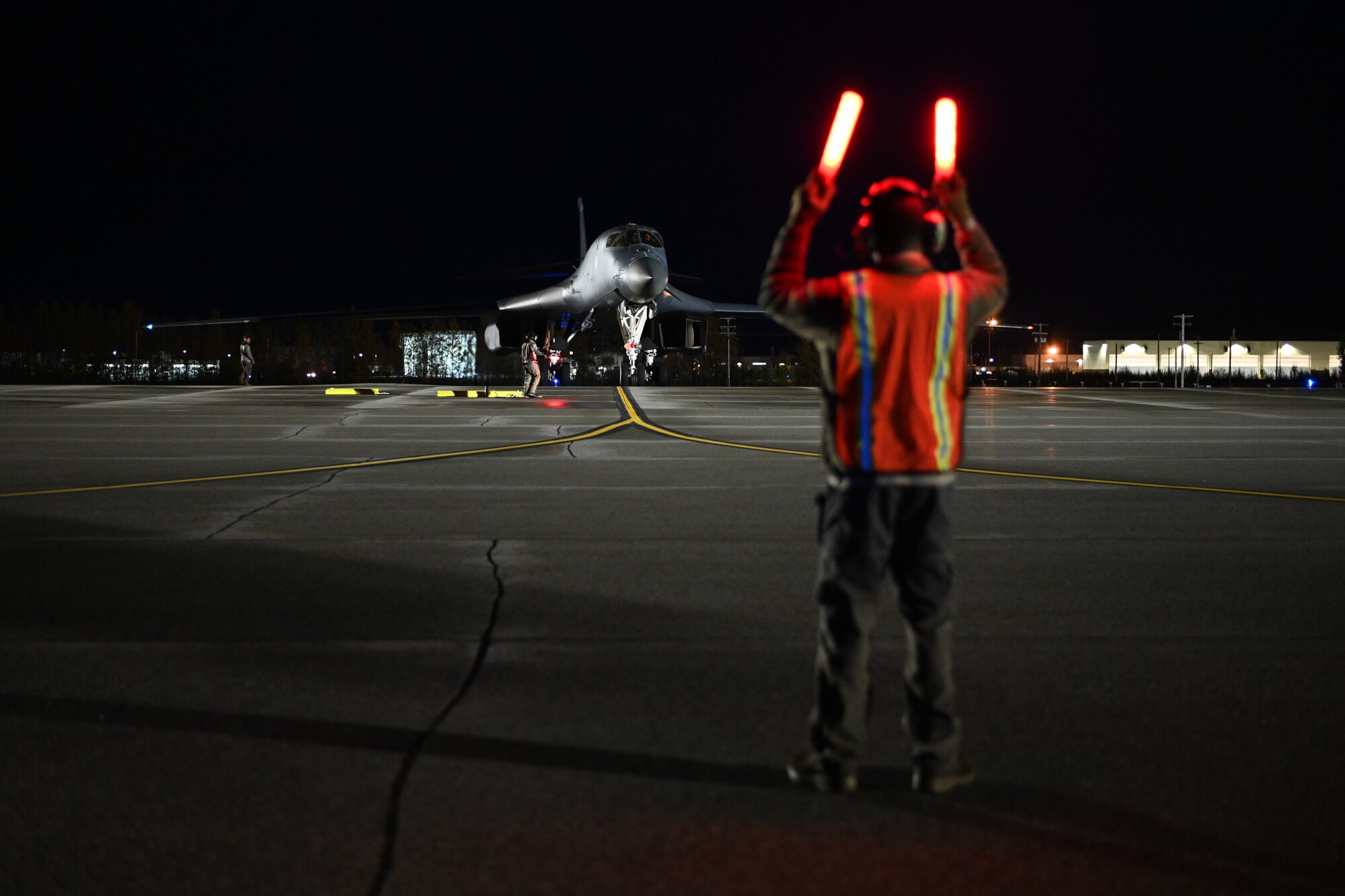 Airman conducting night marshaling.