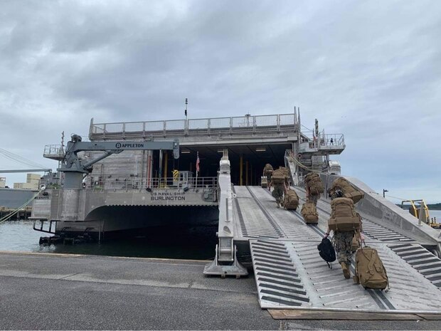 U.S. Marines board the Spearhead-class USNS Burlington (T-EPF 10) at Joint Expeditionary Base Little Creek-Fort Story, Va., Sept. 26.