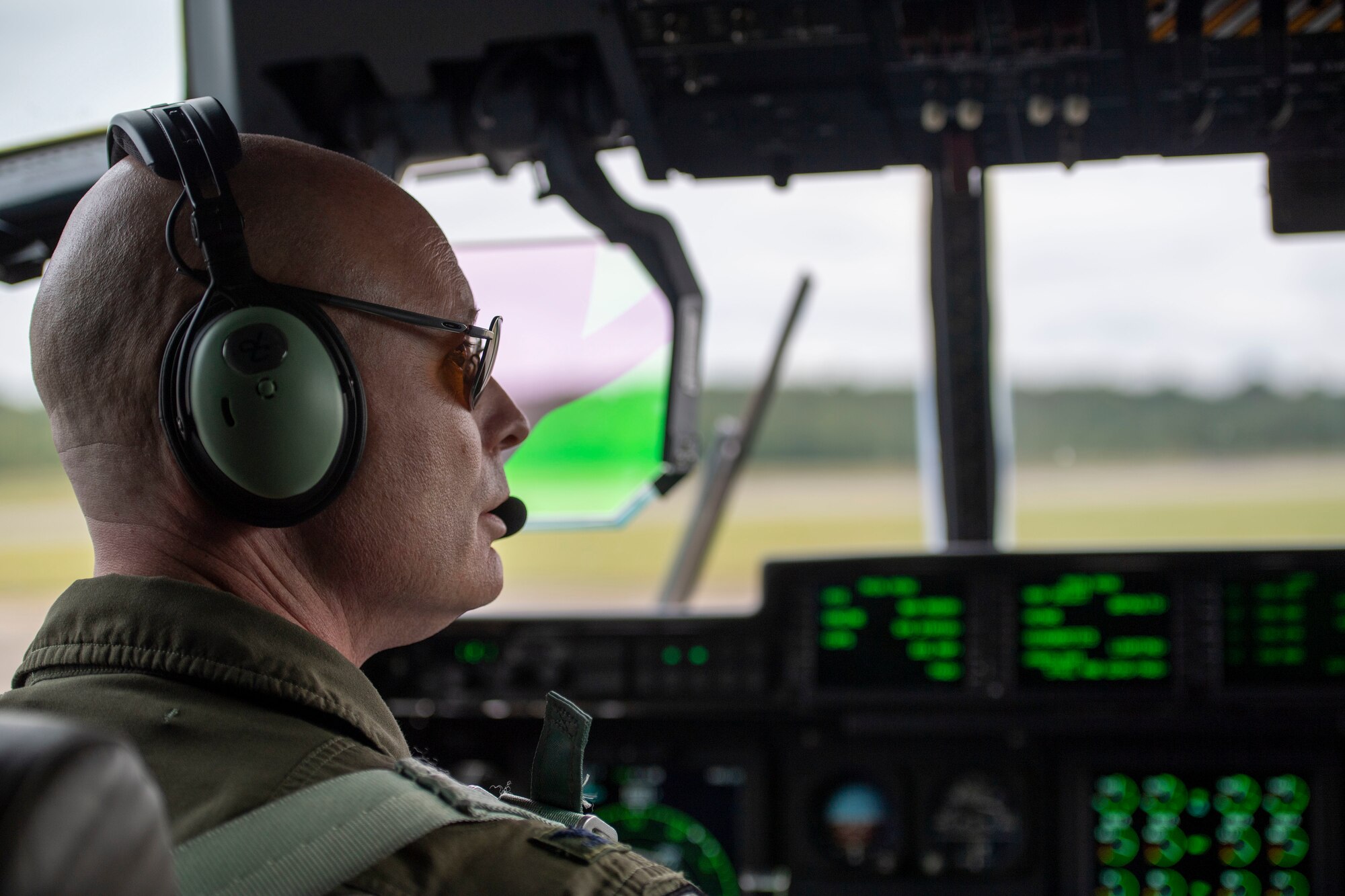 The 314th commander looks out of the cockpit of a C-130J.