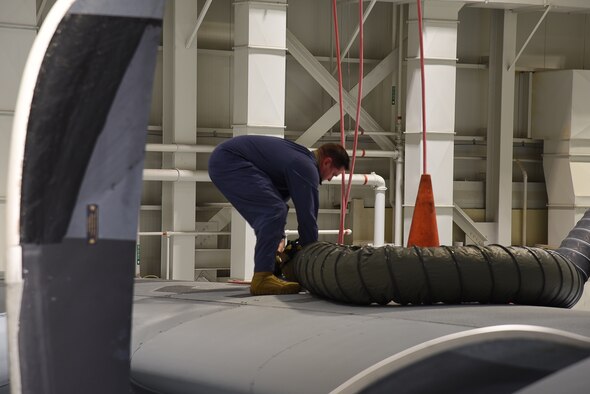 Tech. Sgt. David Deschenes, 403rd Maintenance Squadron fuel systems specialist, extracts 'Rescue Randy' from the fuel tank of the C-130J Super Hercules during a confined space extraction exercise Sept. 30 at Keesler Air Force Base, Miss. This exercise is a combined effort of the 403rd MXS and the  and the 81st Training Wing's Fire Department to ensure that both the fuel systems specialists and the emergency responders are able to safely extract patients from any confined space at any time. (U.S. Air Force photo by Jessica L. Kendziorek)