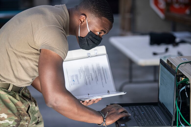 Airman Chandler Lawrence, a member of the 380th Expeditionary Communications Squadron, monitors status reporting on the Hawkeye satellite communication system display, Sept. 25 2020 at Al Dhafra Air Base, United Arab Emirates.